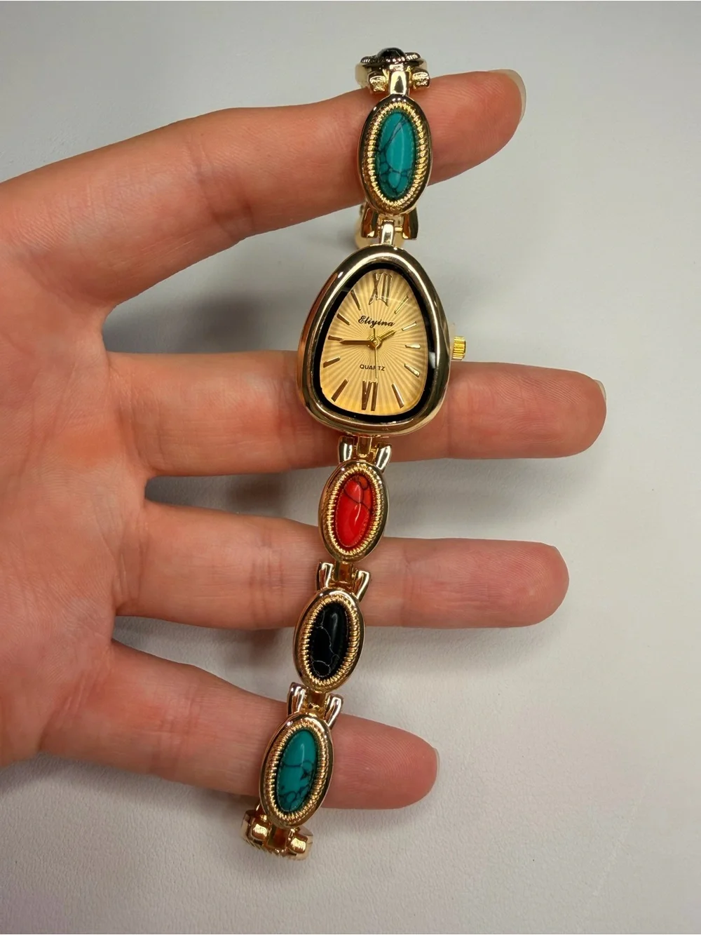 Gold Teardrop Dial Bracelet Watch with Red, Black and Turquoise Accents